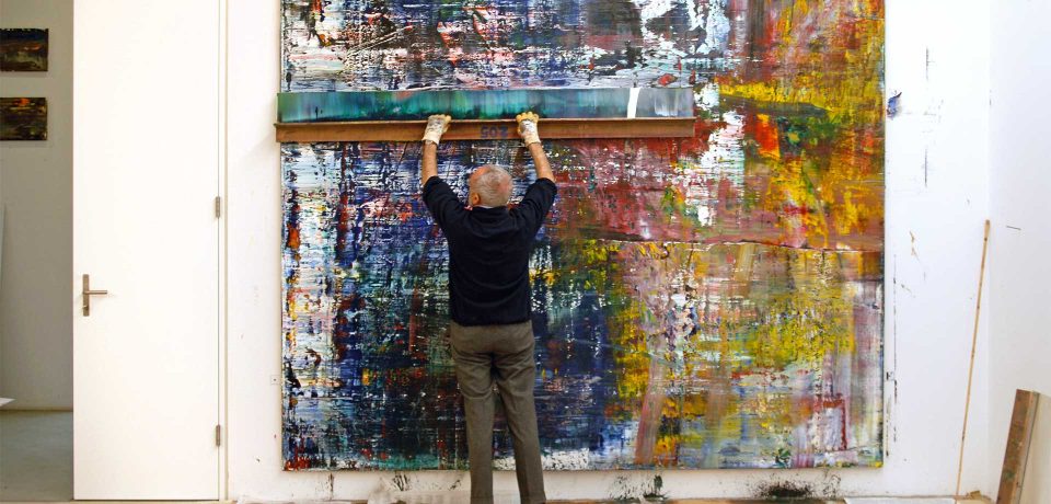 Gerhardt Richter in the studio, applying paint on a very large canvas using a giant squeegee